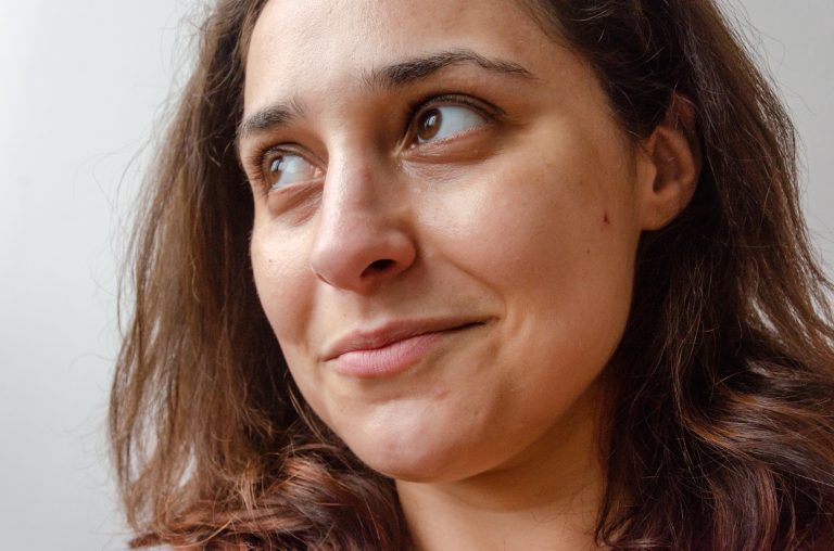 closeup on latin brunette woman face looking hopeful happy