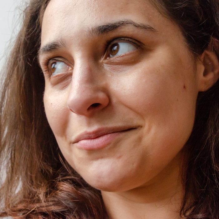 closeup on latin brunette woman face looking hopeful happy