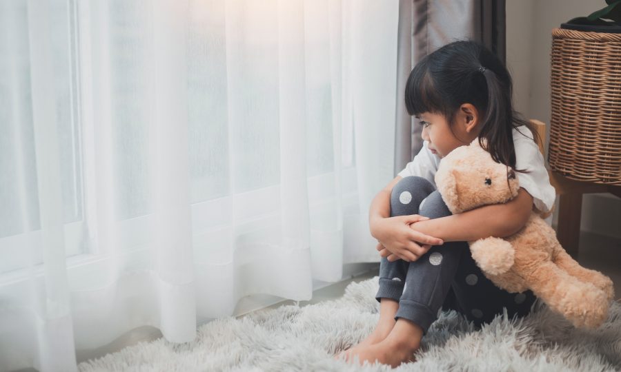 lonely little girl hugging toy, sitting at home alone, upset unhappy child waiting for parents,